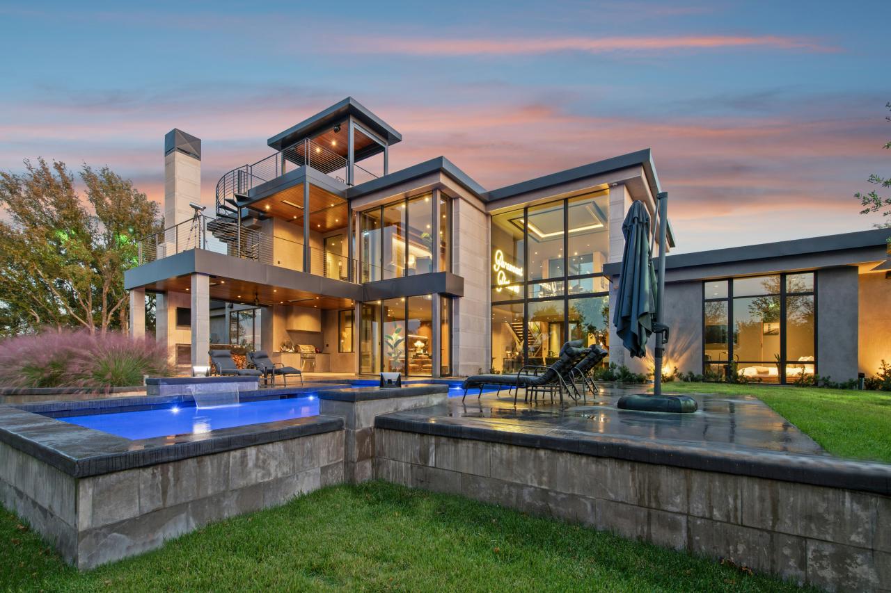 Modern luxury home with swimming pools at dusk